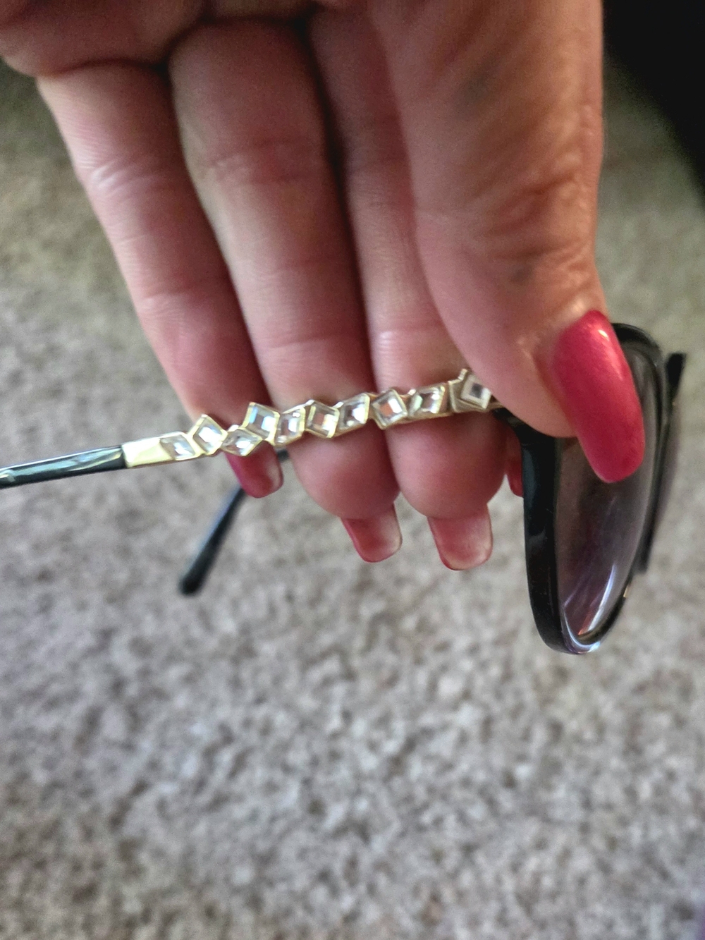 Swarovski designer eyeglasses or sunglasses featuring a row of faceted, geometri